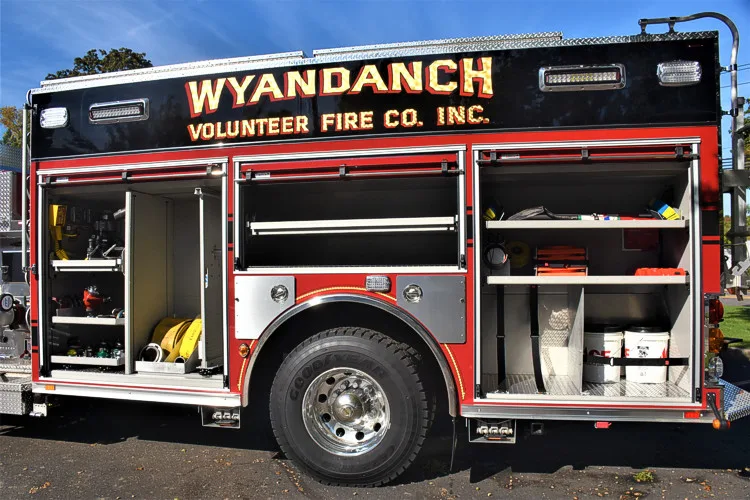 Driver-side profile with open compartments showing trays and shelf storage