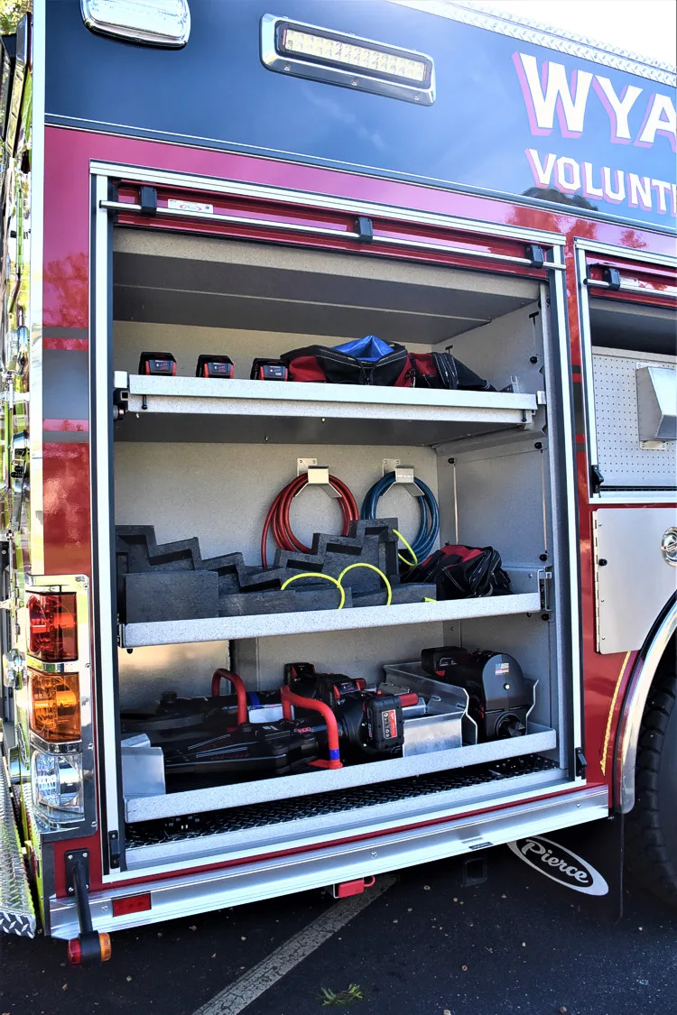 Open side compartment showing nozzles and gear organized on shelves