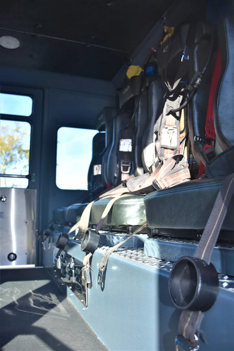 Cab interior side view showing rear seat and aisle space