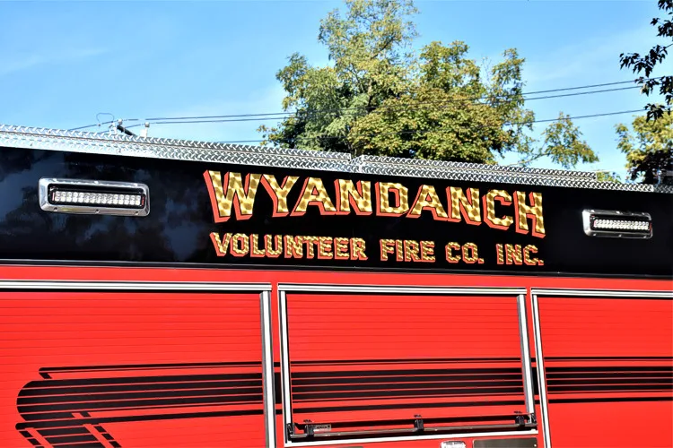 Body side lettering close-up on black panel above red body section