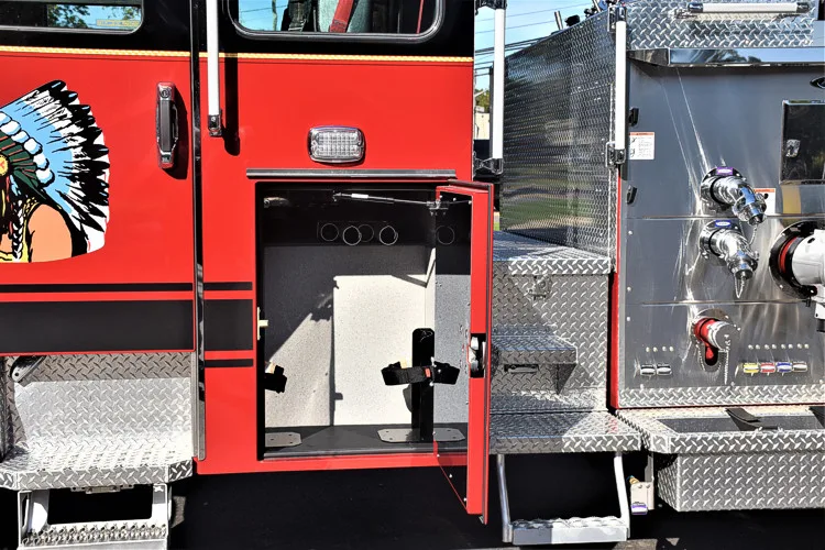 Driver-side mid-body view showing open panel near pump controls