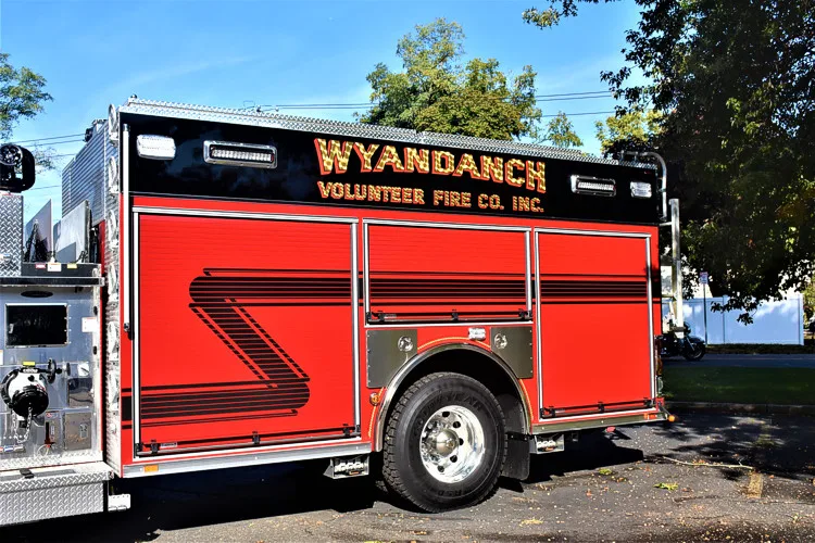 Driver-side profile view showing pumper body and rear wheel area