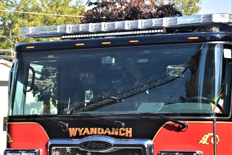 Front-right cab close-up showing windshield, mirror, and crest badge