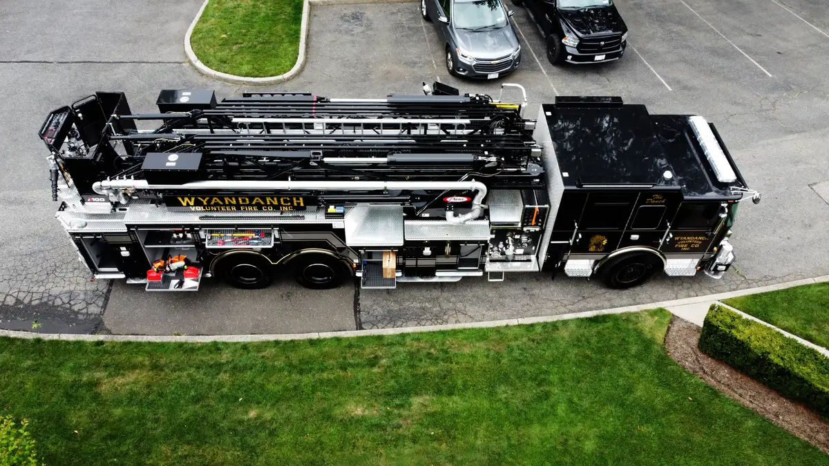 Aerial top-down side view showing full truck profile and ladder sections