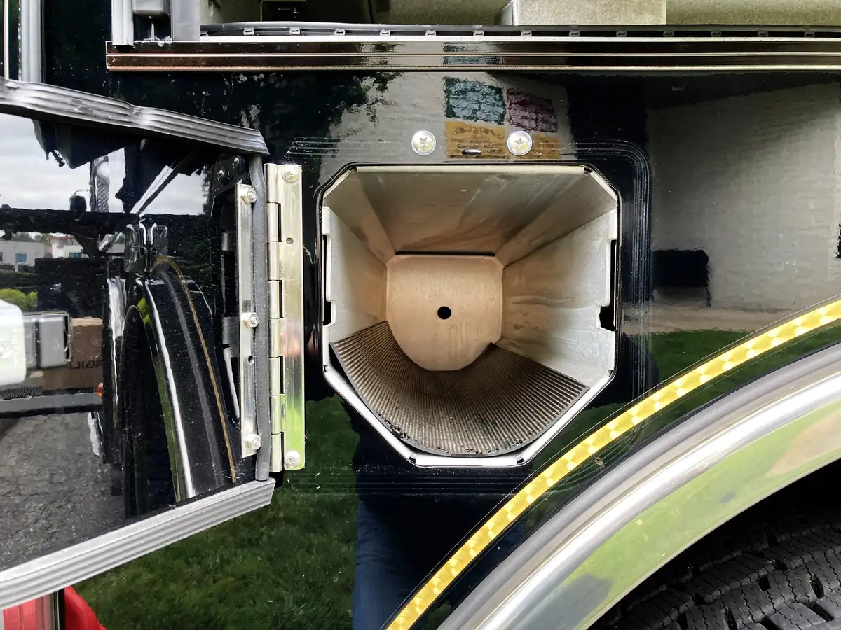 Open side compartment with wiring panel showing labeled electrical modules