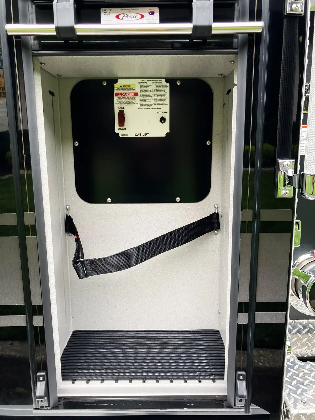 Open side compartment showing control modules and wiring panel