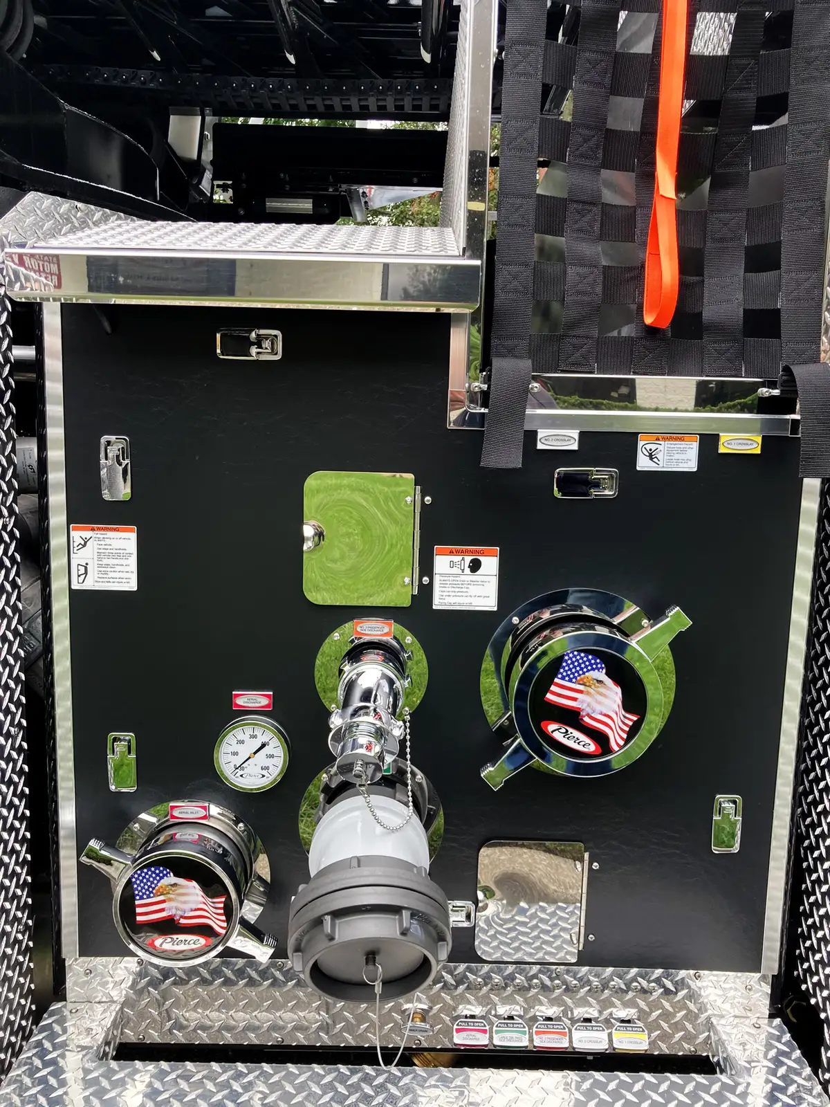 Open side compartment showing power distribution controls and cable bundles