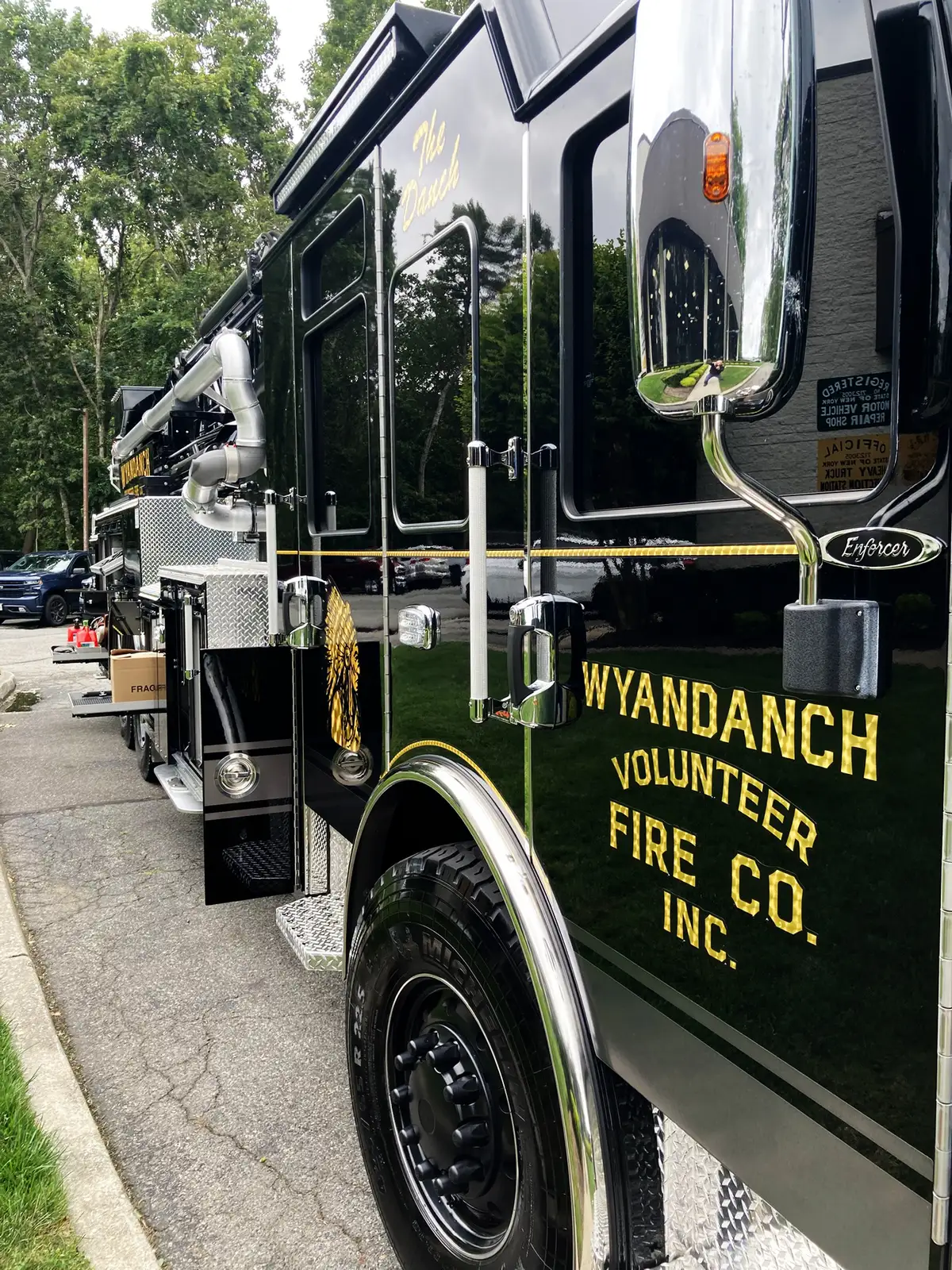 Open rear-side compartment showing framed storage slots and lower tray