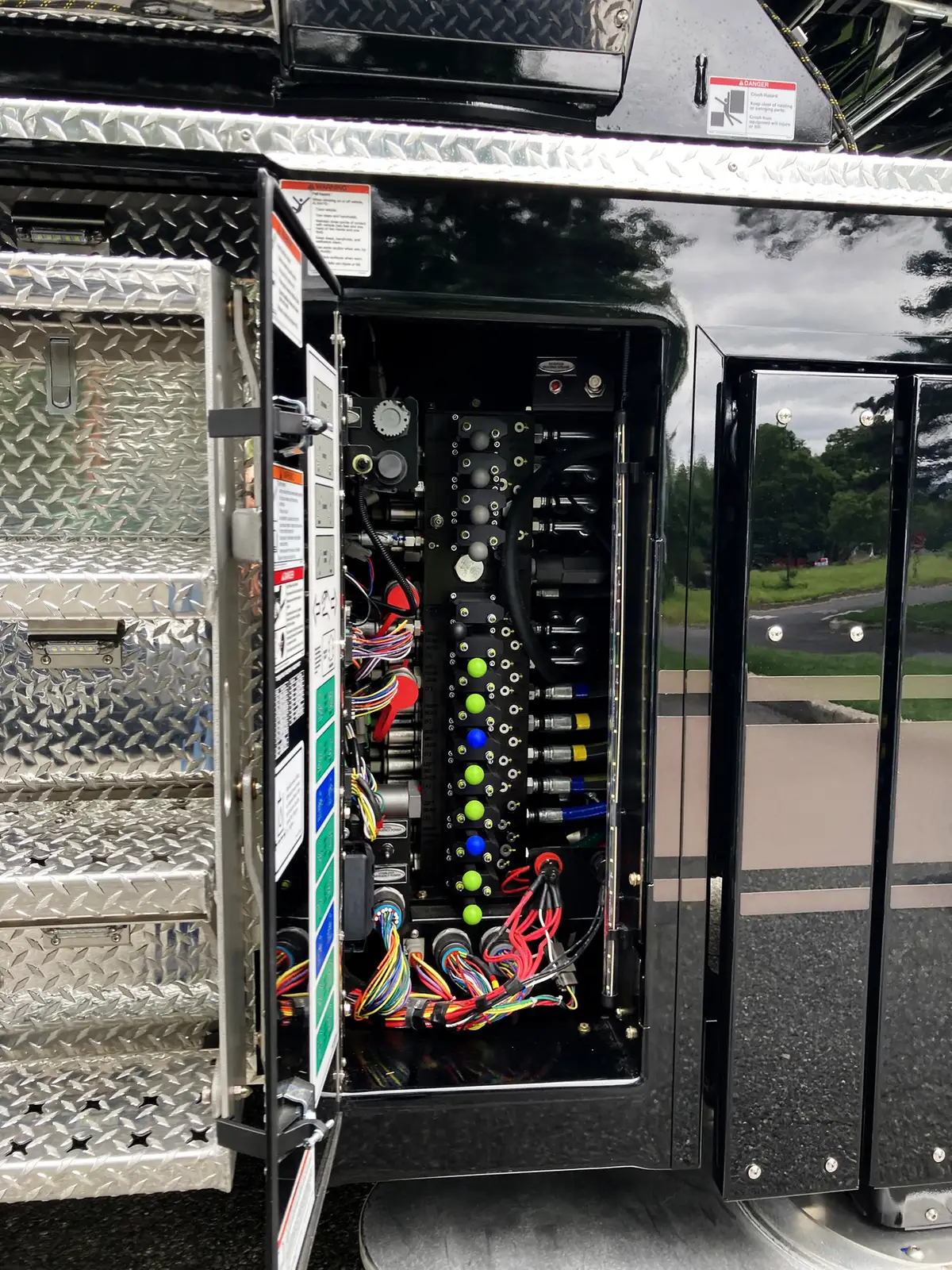 Open lower side compartment showing electronic control screens and switches