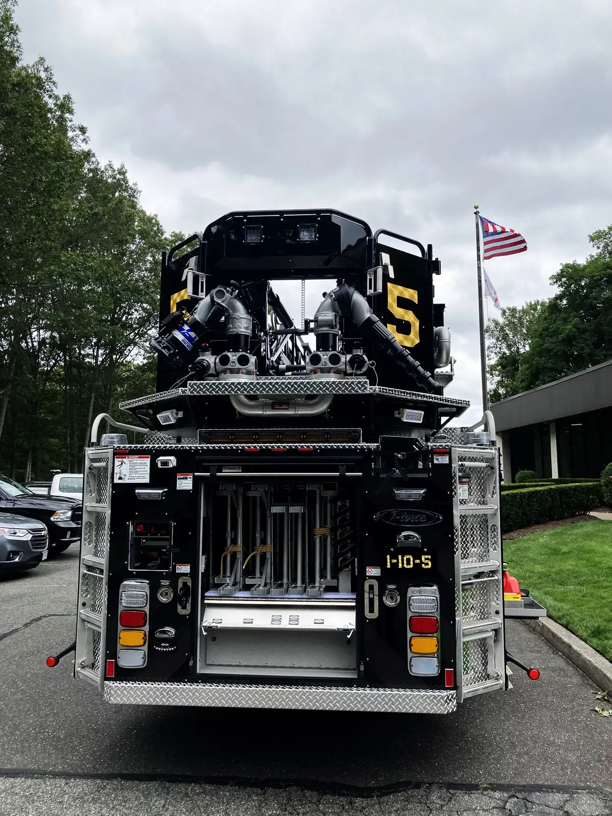 Rear view showing ladder access, intake outlets, and open center compartment