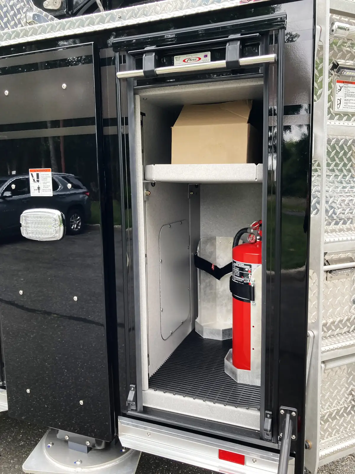 Front bumper corner close-up showing diamond-plate step and chrome trim
