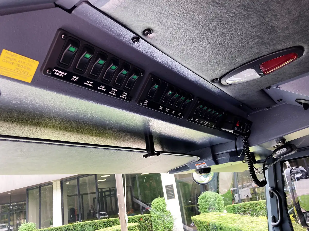 Cab interior close-up showing overhead switch panel and radio area