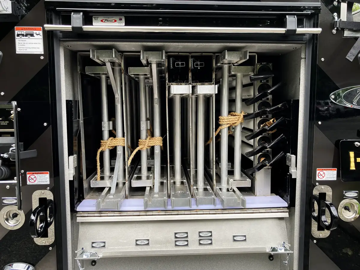 Open rear-side compartment showing ladder rack channels and mounts