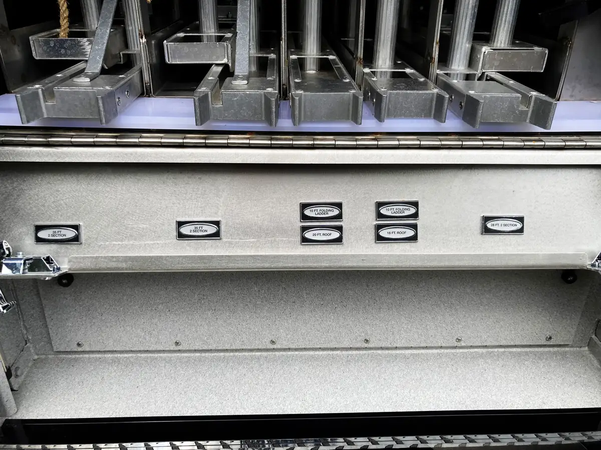 Rear ladder storage compartment close-up with labeled ladder slots