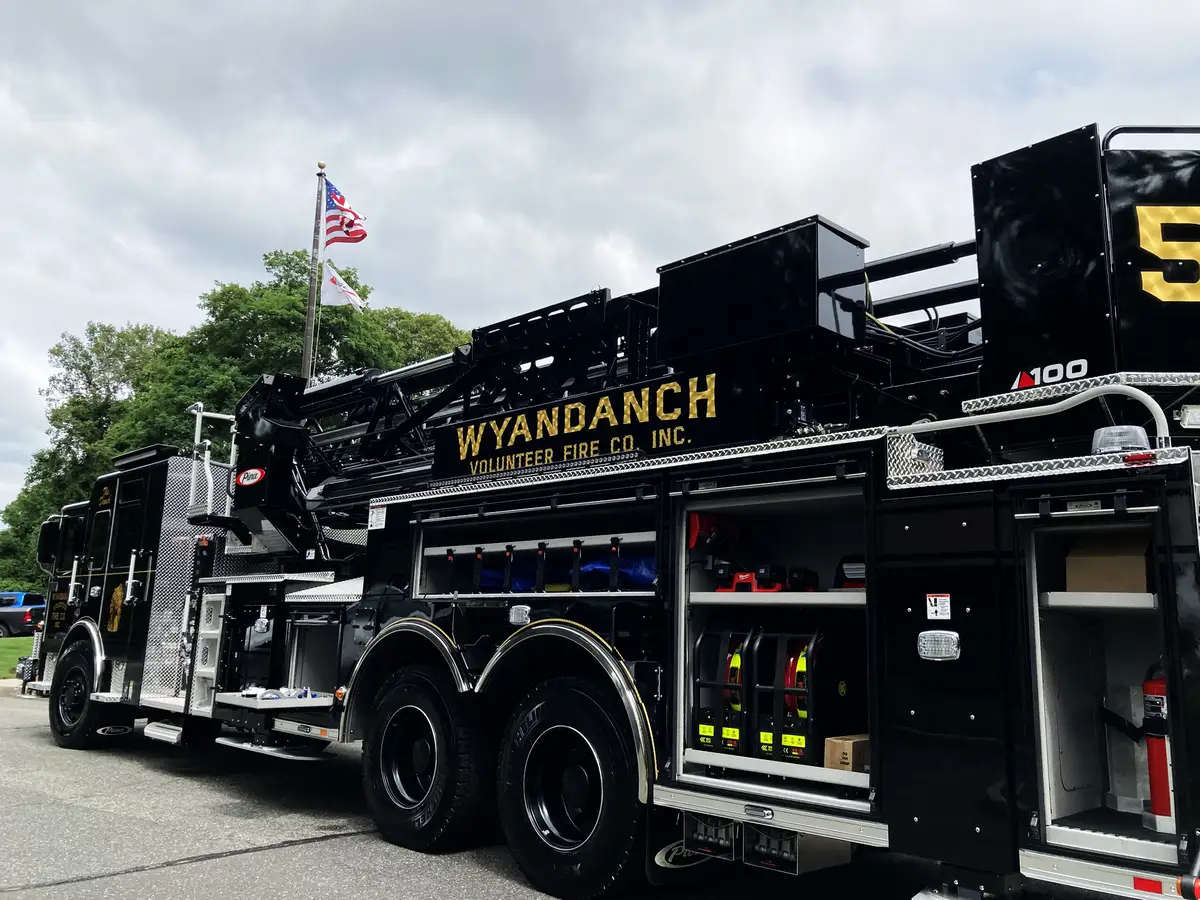 Front-left exterior view showing black cab, grille, and bumper