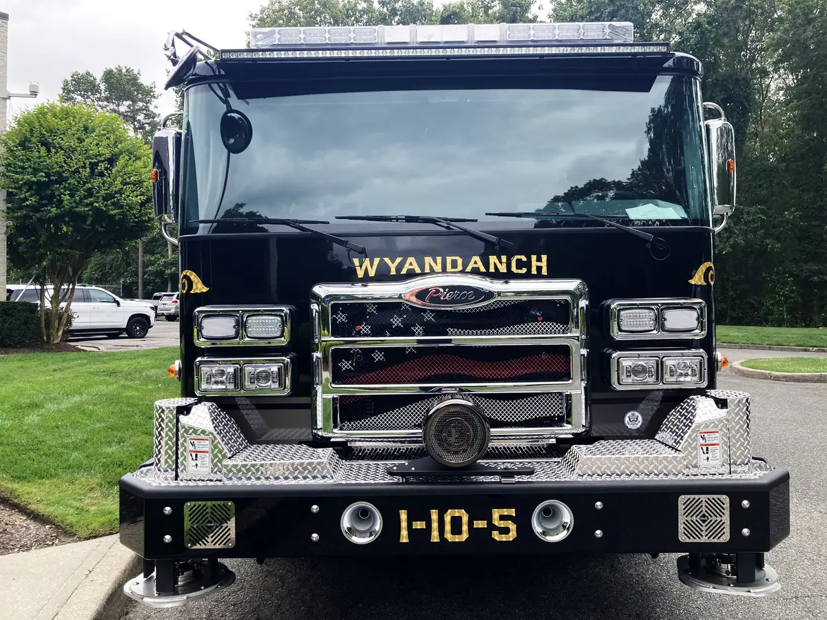 Head-on front view showing grille, bumper intakes, and warning lights