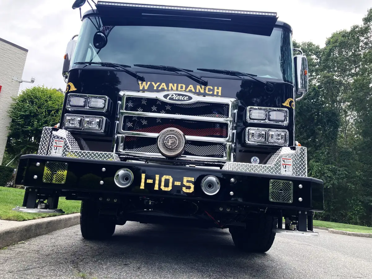 Front low-angle view showing bumper, grille, and front warning lights