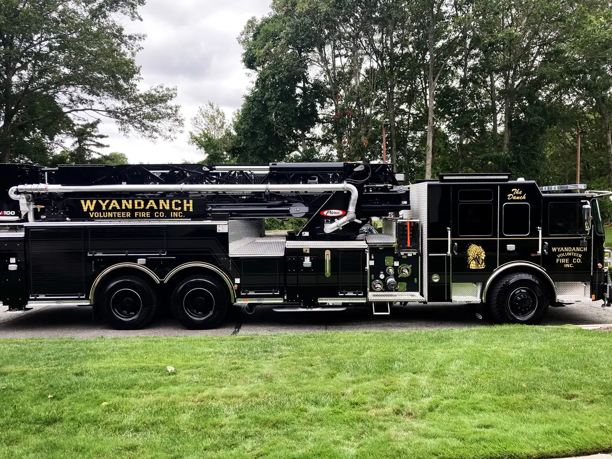 Driver-side profile with outrigger deployed showing stabilizer arm and pad