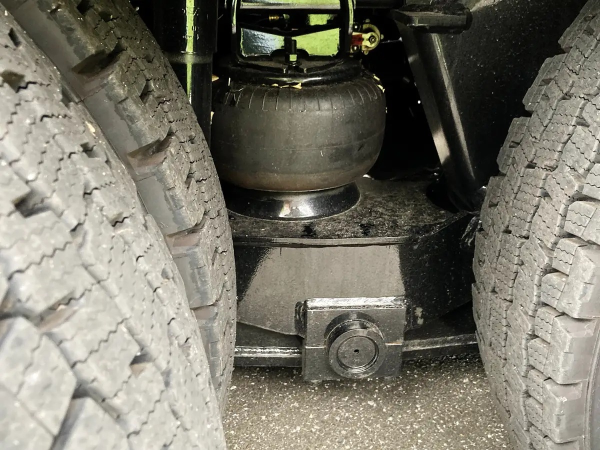 Dual rear-tire close-up showing suspension airbag and tread