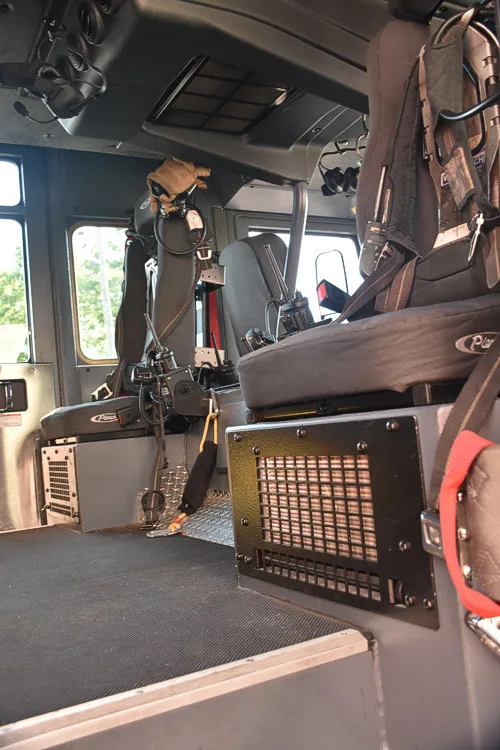 Cab interior side view showing front seats and center console area
