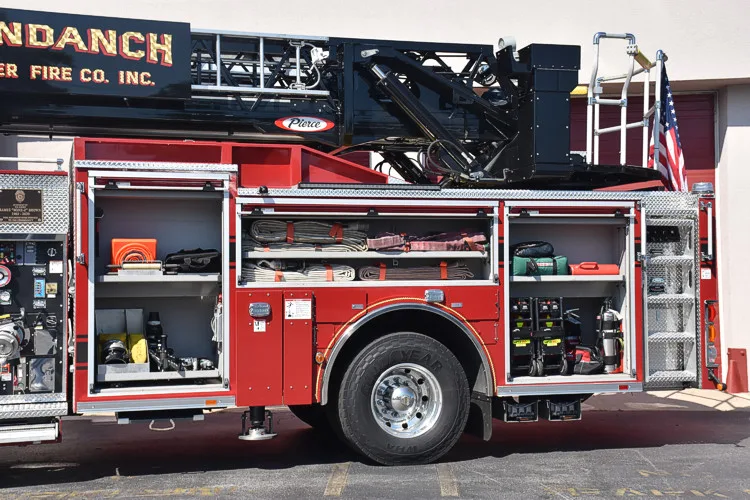 Driver-side profile with open compartments showing full equipment layout