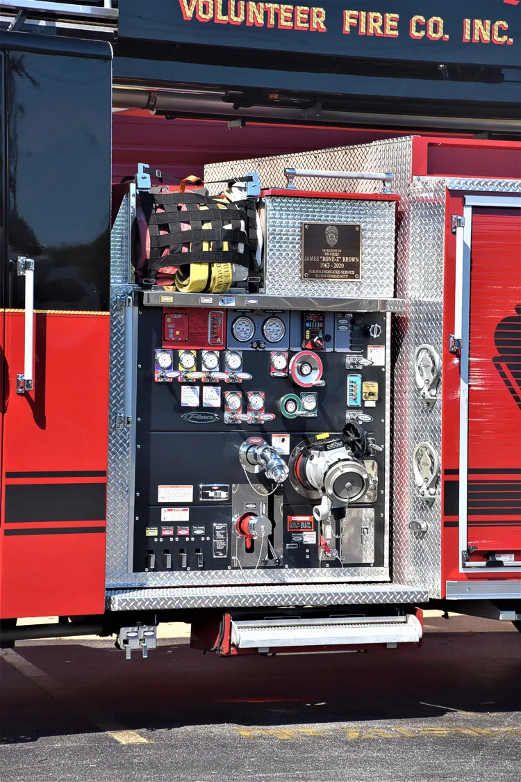 Pump panel close-up showing control gauges and intake hardware