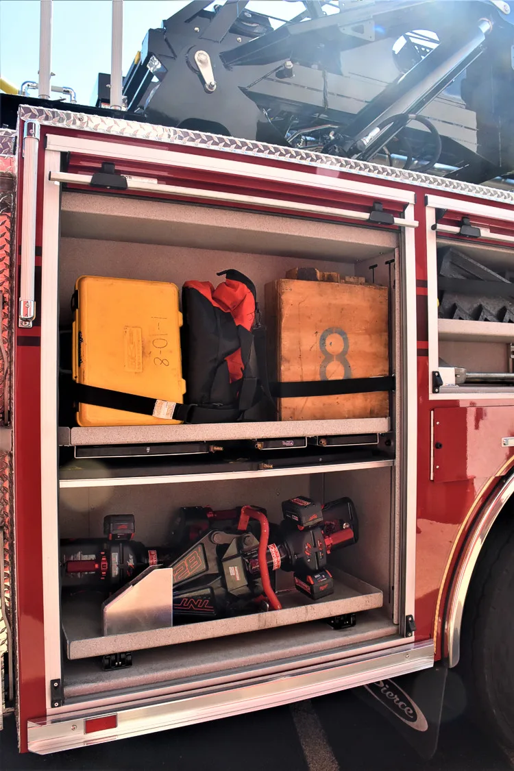 Open side compartment showing nested trays and stored equipment