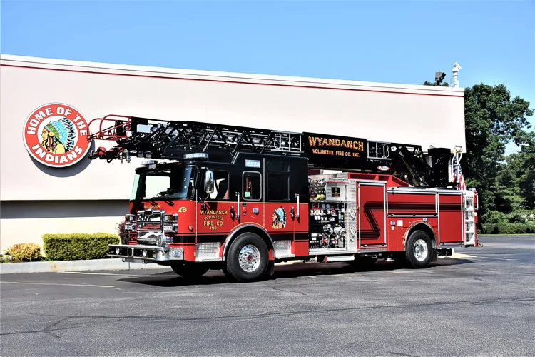 Aerial ladder truck driver-side profile showing full body and ladder bed