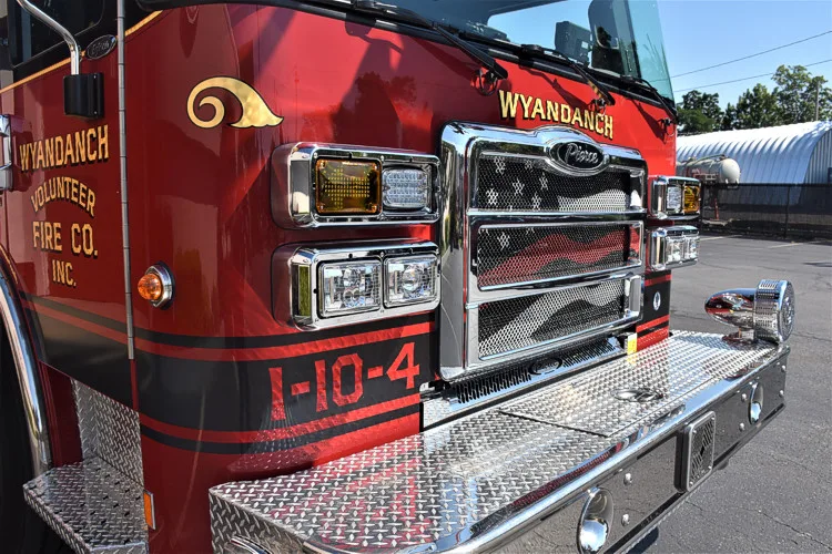 Front bumper close-up showing intake ports, grille, and warning lights