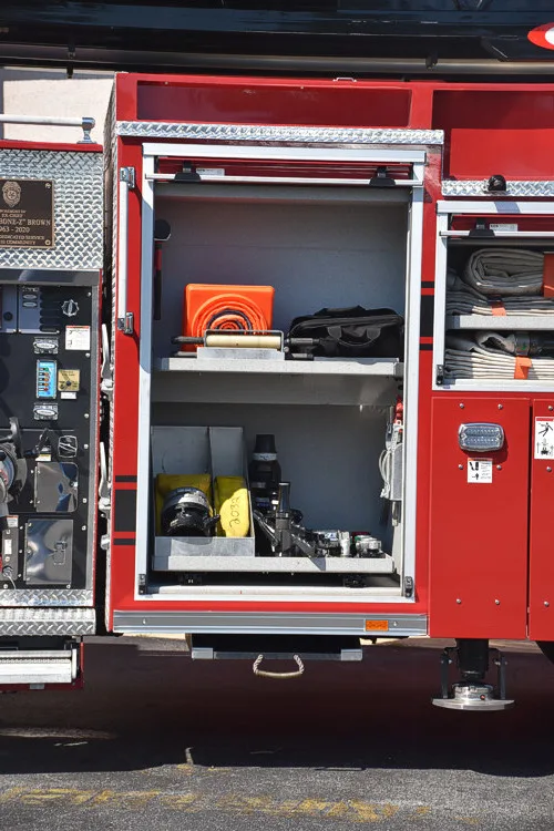 Open side compartment showing tool cases and shelf-mounted equipment