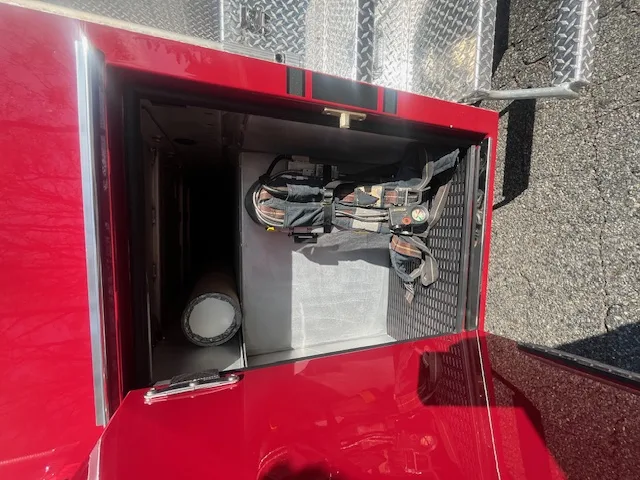 Rear view showing chevron striping, hosebed opening, and rear hose connections