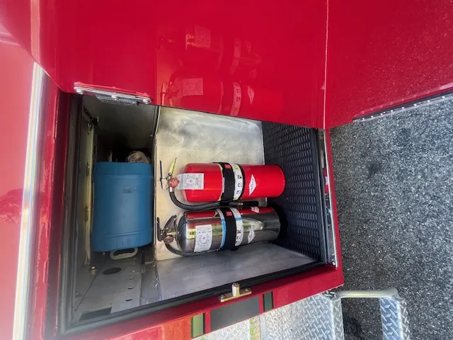 Open side compartment with fire extinguishers and utility storage