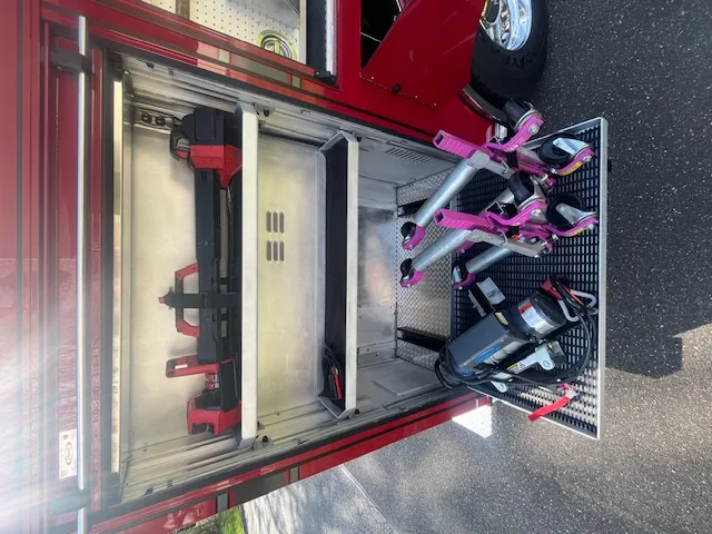 Rear view with chevron striping, hosebed, and hose reel compartment open