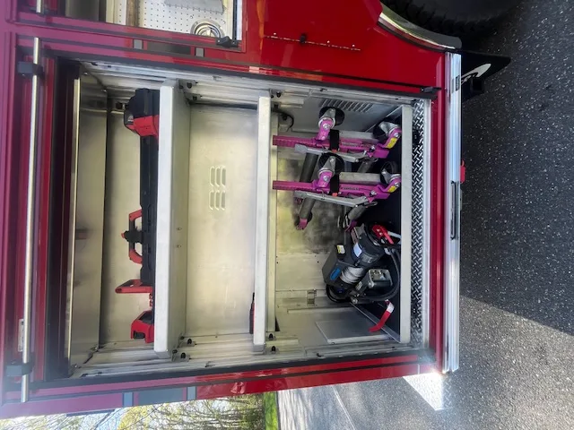 Open side compartment showing stabilizing struts and extrication tools on pull-out tray