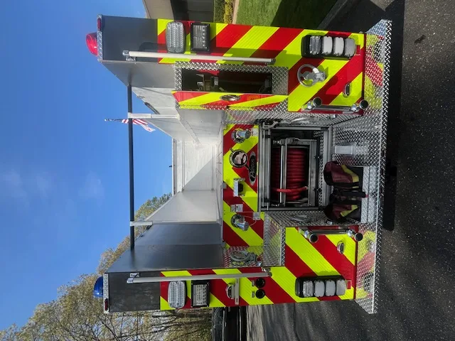 Open side compartment with pull-out tray showing extrication tools and struts