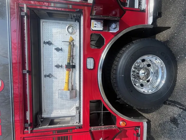 Open side compartment close-up with mounted hand tools and rear wheel