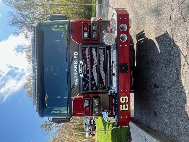 Pierce Enforcer top-mount pumper front view showing grille, bumper, and warning lights